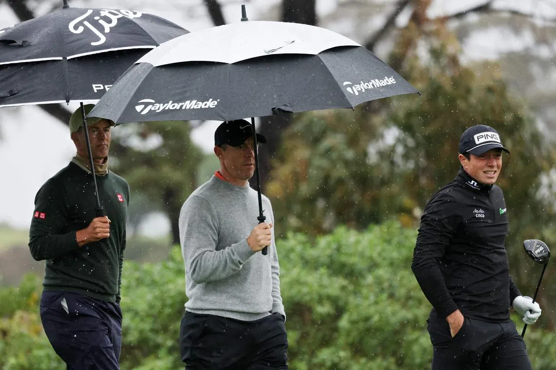 The group of Adam Scott of Australia, Rory McIlroy of Northern Ireland, and Viktor Hovland of Norway walks off the fifth tee during the first round of The Genesis Invitational 2025.