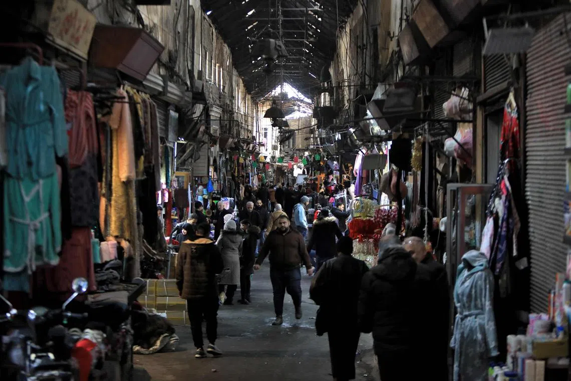 People walk in the Medhat Pasha market in the old part of the capital Damascus, on Dec 28, 2024.