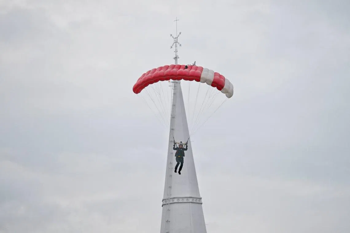 Red lions descending to the Padang during National Day Parade on Aug 9, 2024.