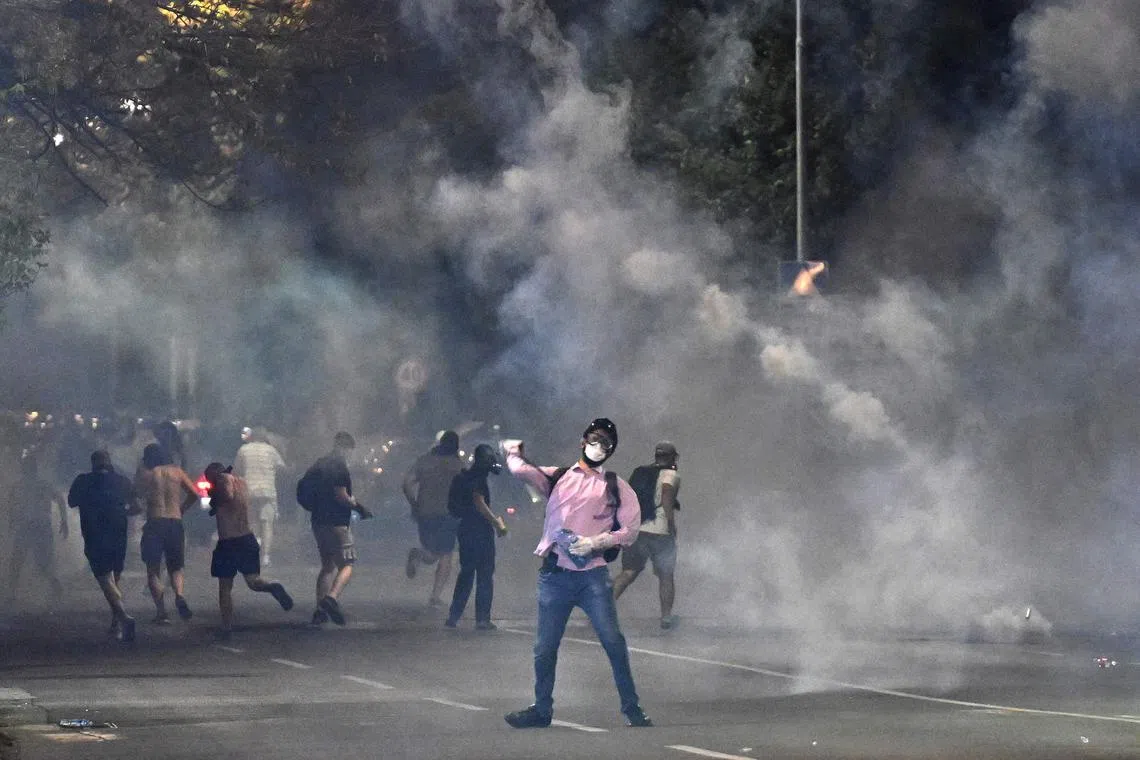Demonstrators standing in clouds of tear gas during anti-government protests in Belgrade on Aug 16.