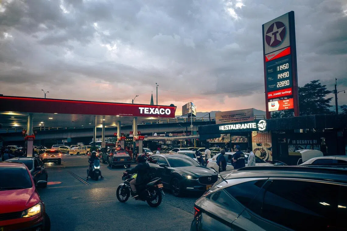 Vehicles line up at a Texaco petrol station during rush hour on  March 19, 2026, in the San Diego neighbourhood of Medellín, Colombia.