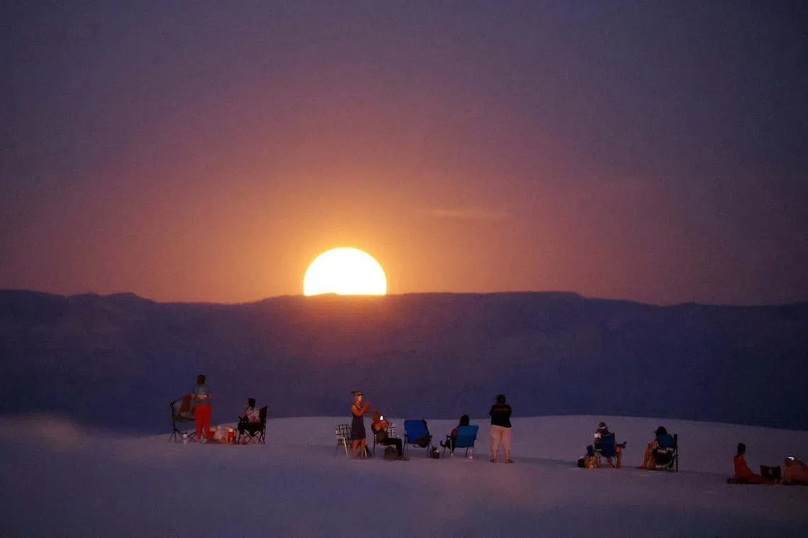 People gather to watch the supermoon at White Sand National Park near Alamogordo, New Mexico, U.S., Aug 19, 2024.