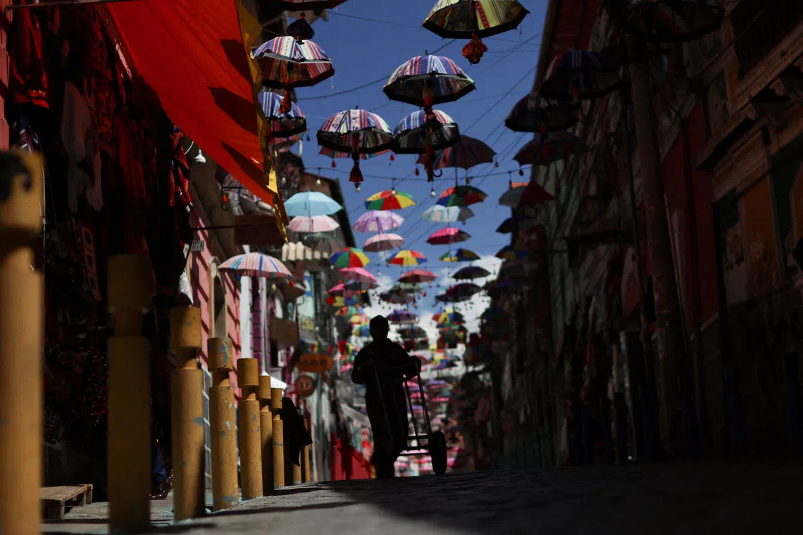A man walking at the Mercado de las brujas (witches' market) ahead of the Oct 19 runoff election, in La Paz, Bolivia, on Oct 16, 2025.