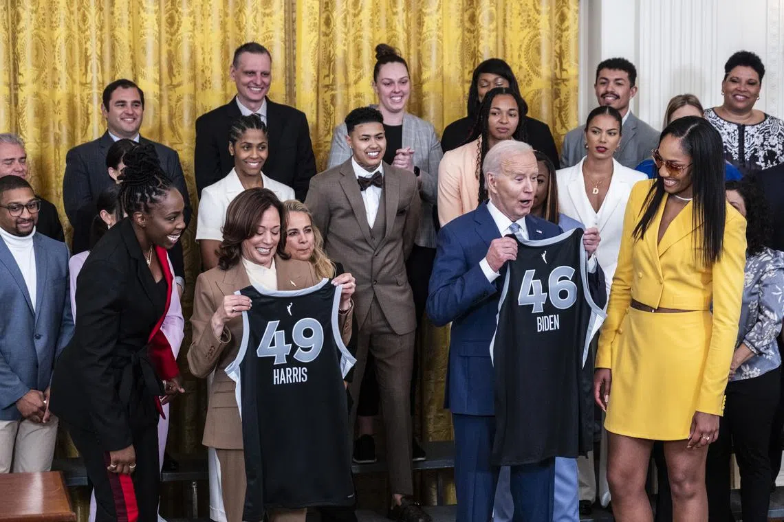 US President Joe Biden and Vice- President Kamala Harris are presented with jerseys during a ceremony in the East Room to welcome the 2023 WNBA champions Las Vegas Aces to the White House on May 9, 2024.