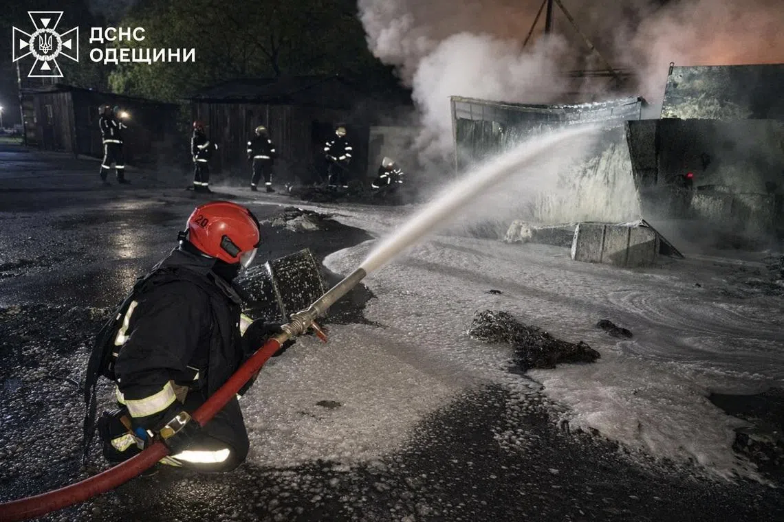 Firefighters work at a compound of a port on the Danube river which was hit during overnight Russian drone strikes, amid Russia's attack on Ukraine, in Odesa region, Ukraine April 17, 2026. Picture taken with a mobile phone. Press service of the State Emergency Service of Ukraine in Odesa region/Handout via REUTERS