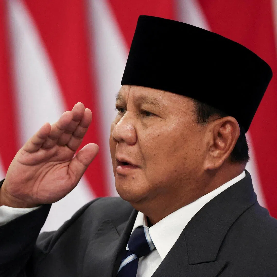 Indonesian President Prabowo Subianto salutes while singing the National Anthem at the State Palace in Jakarta on June 8.