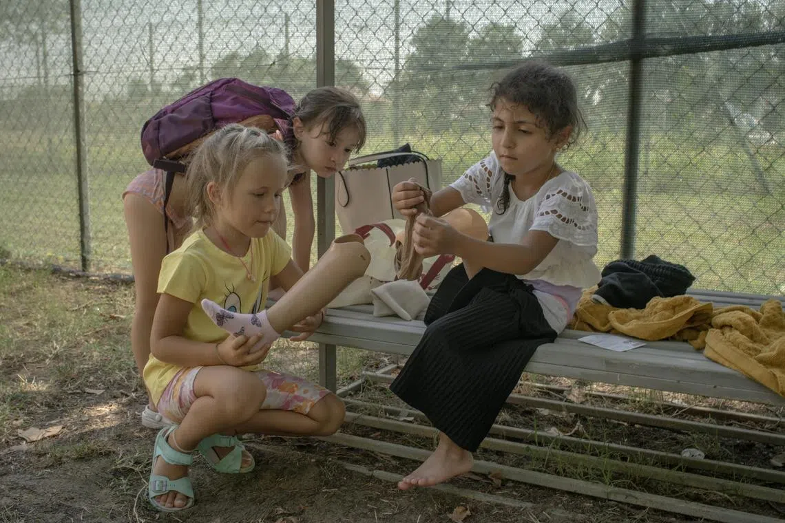 Shaymaa Shady, a six-year-old who was evacuated from Gaza, is peppered with questions from Italian children as she adjusted her prosthetic leg, at summer camp in Bologna on July 17, 2024. Children like Shaymaa face not only difficult recoveries but also the challenges of schoolyards and camps filled with peers who neither speak their language nor know much about the devastation in Gaza. ÒHa fatto la guerra,Ó one child said of Shaymaa. ÒShe went to war.Ó (Laura Boushnak/The New York Times)


