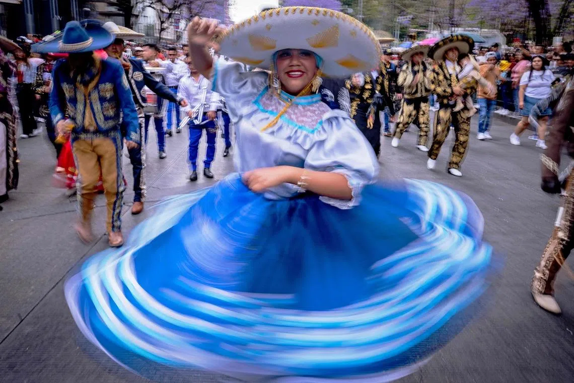 A woman swirling her falda (traditional dancing skirt) during the annual spring carnival parade in Mexico City, Mexico on March 29, 2026. 