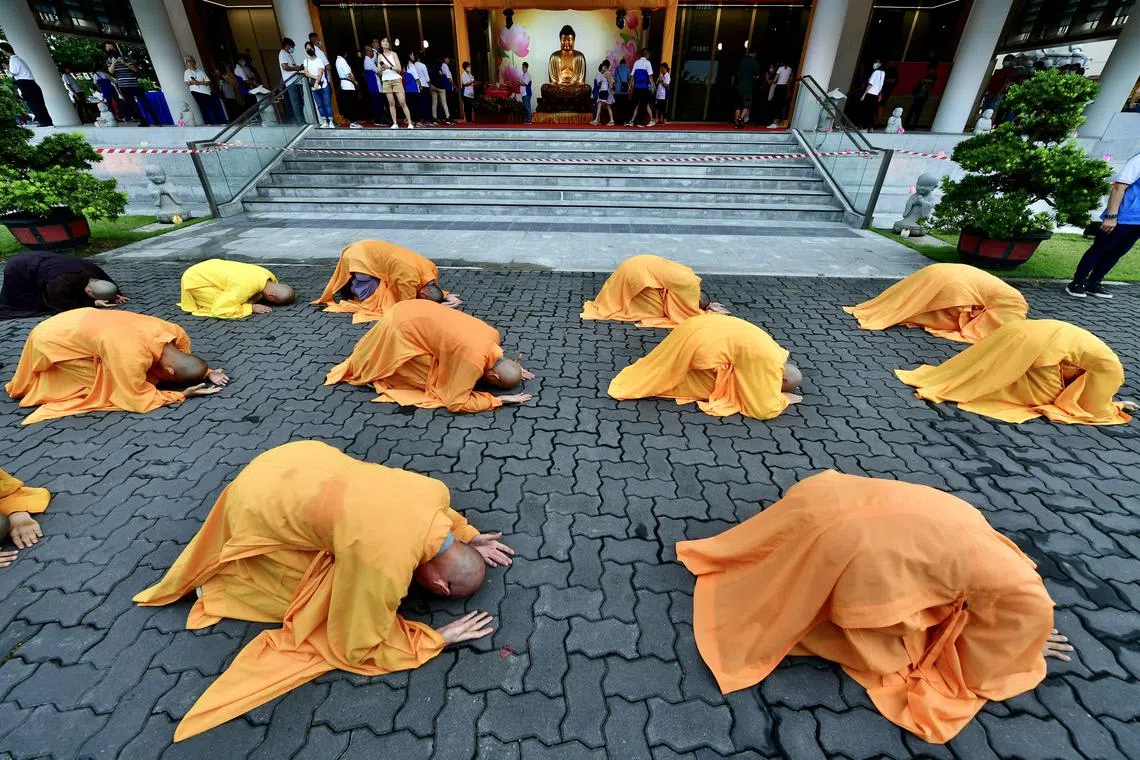 Buddhist monks performing the "three steps, one bow" ritual at the Kong Meng San Phor Kark See Monastery in Bright Hill Road on June 1, 2023, ahead of Vesak Day on June 2. 