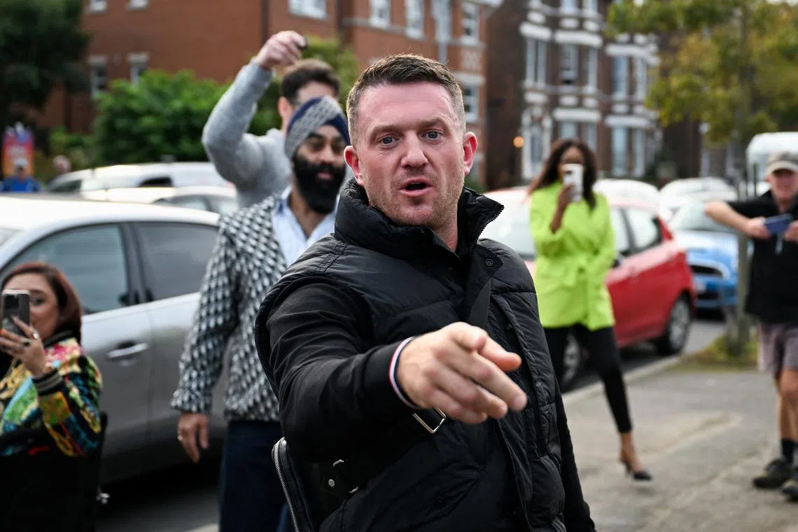 Anti-immigration activist Stephen Yaxley-Lennon, known as Tommy Robinson, gestures before arriving at Folkestone Police Station in Folkestone, Britain, October 25, 2024. REUTERS/Chris J Ratcliffe/File Photo