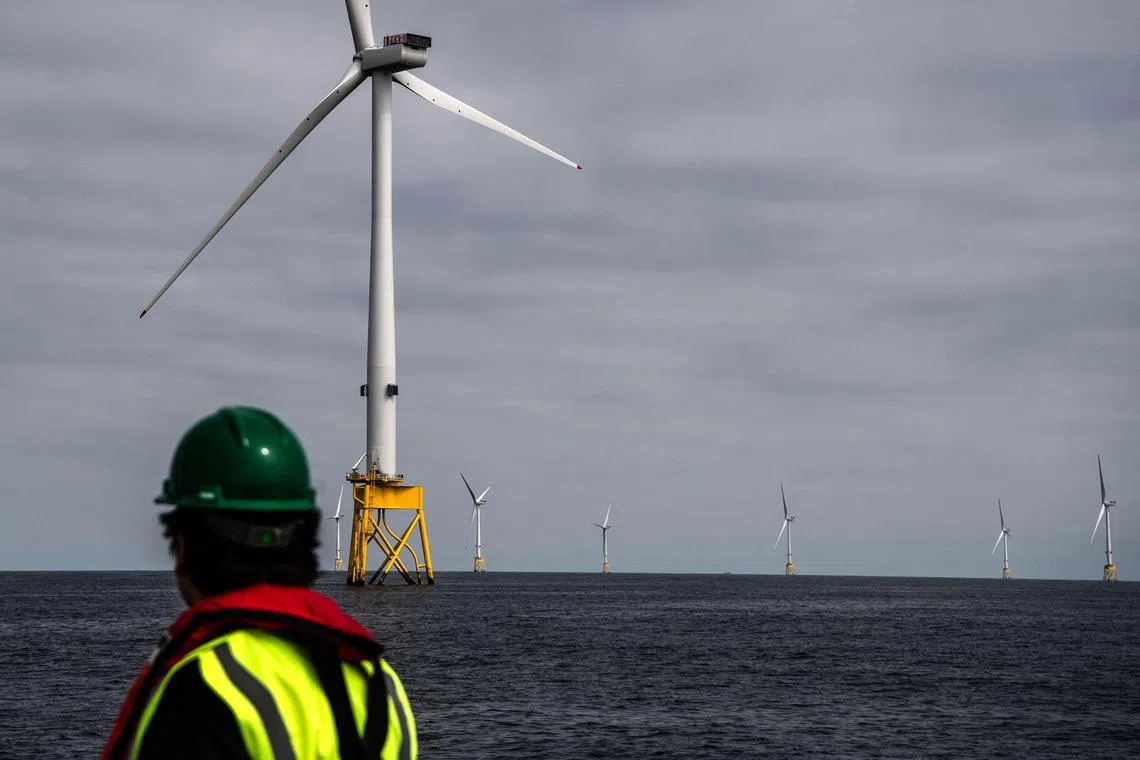 A person looks at wind turbines at the Seagreen Offshore Wind Farm, under construction around 27km from the coast of Montrose, Angus in the North Sea, on June 8, 2023. The Seagreen Offshore Wind Farm is a joint venture between Total Energies (51%) and SSE Renewables (49%) and it will be Scotland’s largest and the world's deepest fixed foundation offshore wind farm once complete. (Photo by Andy Buchanan / AFP)