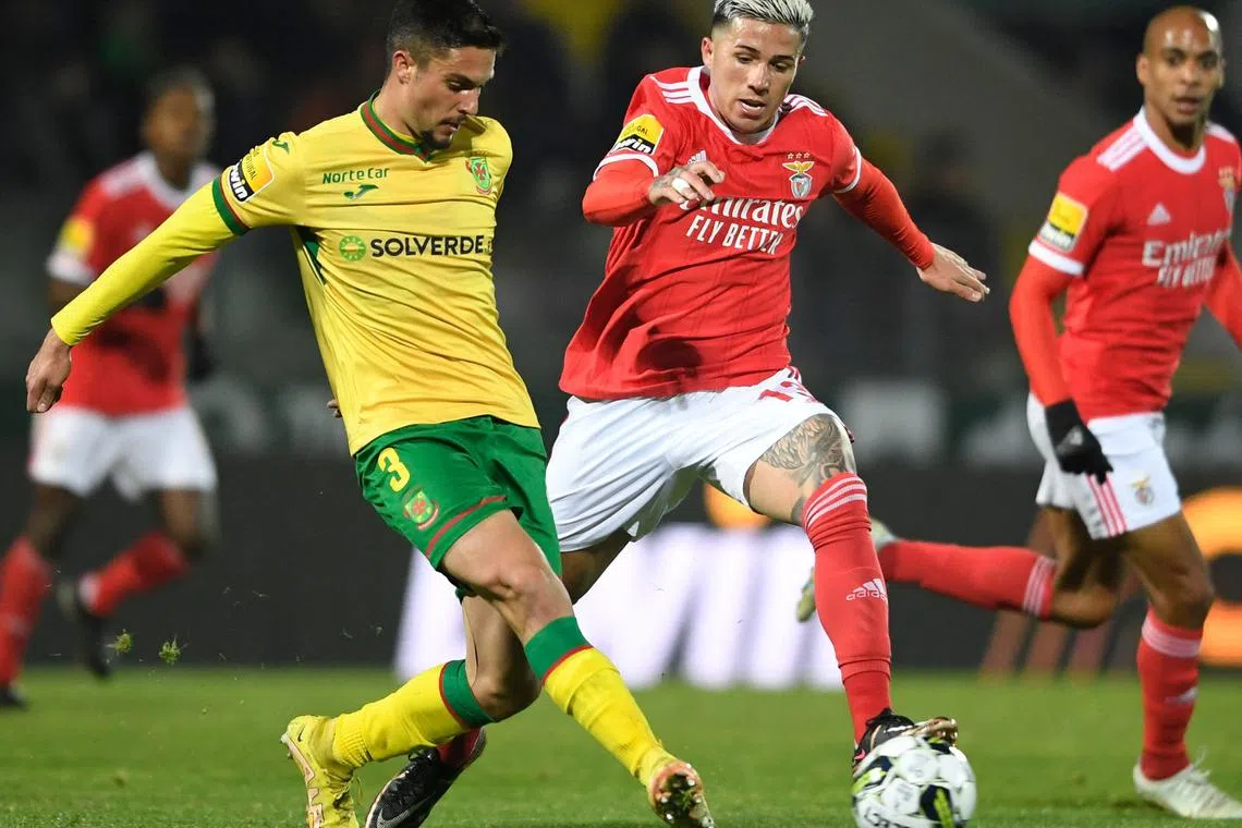 Benfica's Enzo Fernandez (right) fights for the ball with Pacos de Ferreira's Nuno Lima during a Portuguese league football match on Jan 26, 2023.