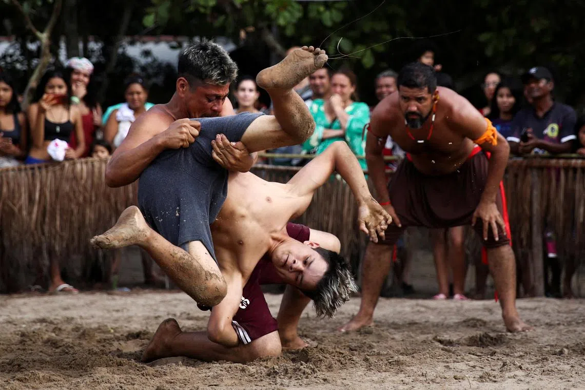 People wrestle during the Indigenous Games in Peruibe, Brazil April 23, 2023. 