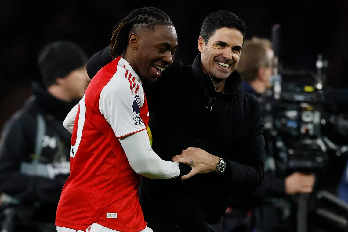 Arsenal's Eberechi Eze and manager Mikel Arteta celebrate after the match.