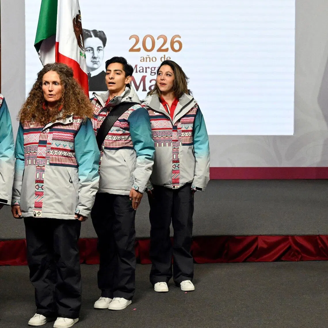 Mexico’s President Claudia Sheinbaum and athletes (from left) Allan Corona, Sarah Schleper, Donovan Carrillo and Regina Martinez singing the national anthem at the flag-raising ceremony for the Mexican delegation that will participate in the Milano-Cortina 2026 Winter Olympic Games, after her daily press conference at the National Palace in Mexico City on Jan 12, 2026.