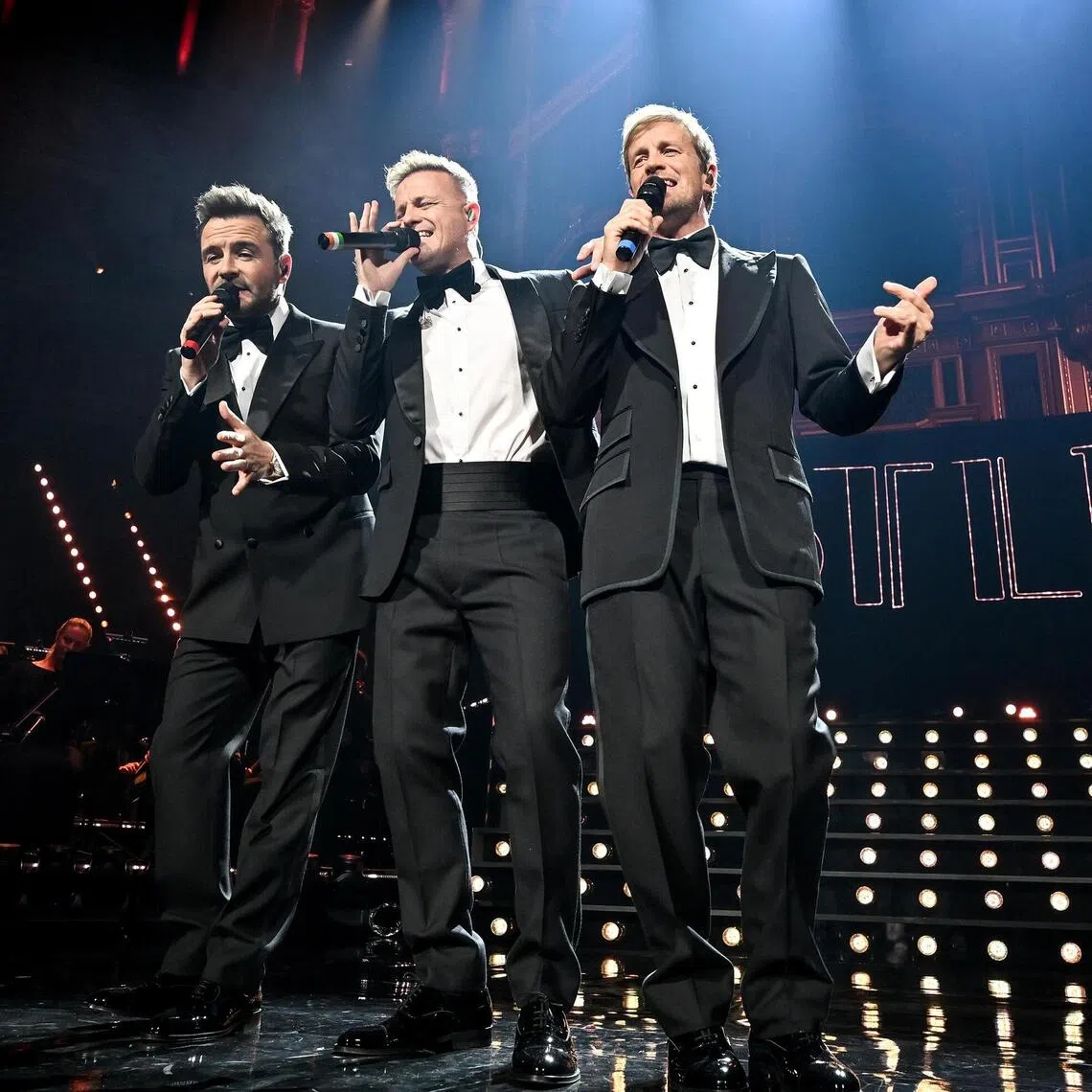Westlife's Shane Filan, Nicky Byrne and Kian Egan during their performance at the Royal Albert Hall in London, England, on Oct 27. 