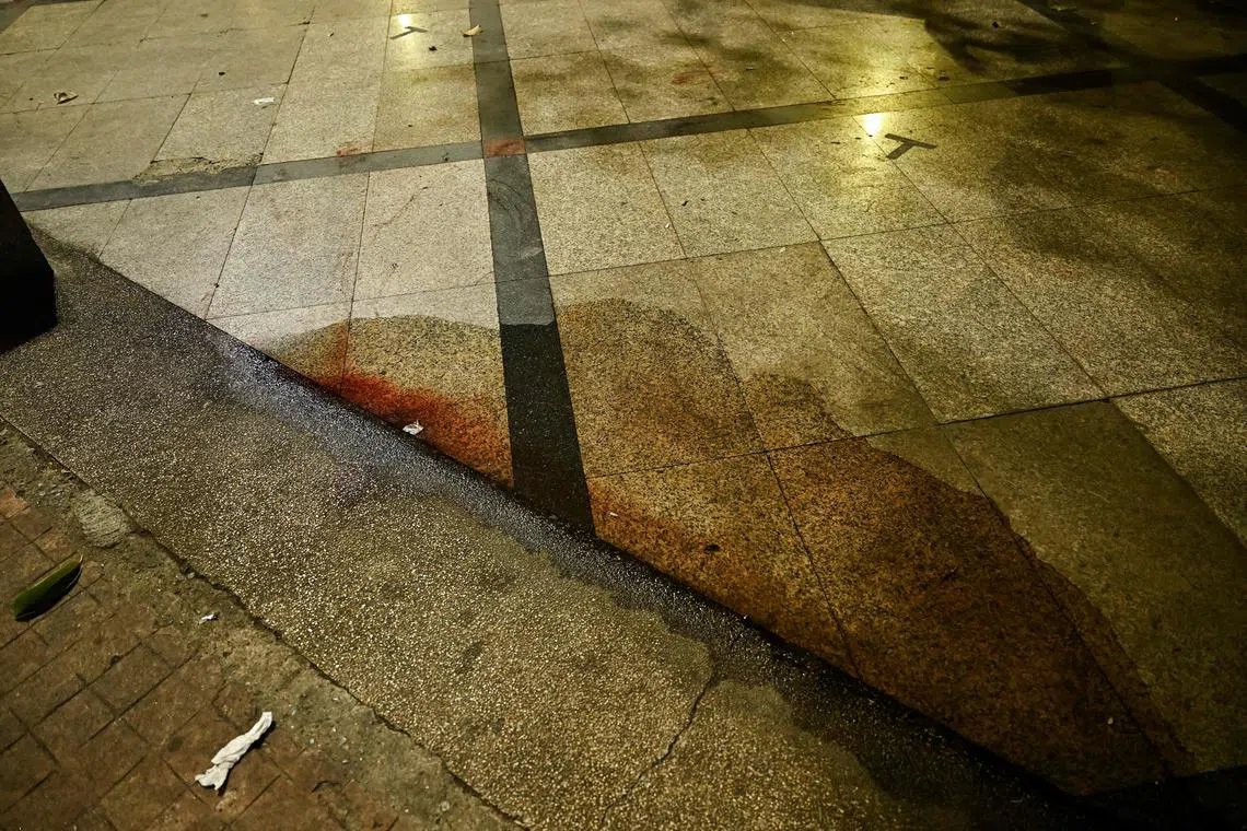 Blood is pictured where a Cambodian MP was reportedly shot, in Bangkok on January 7, 2025. A former Cambodian opposition MP was shot dead by a gunman on a motorcycle in Bangkok on January 7, Thai media reported. (Photo by Lillian SUWANRUMPHA / AFP)