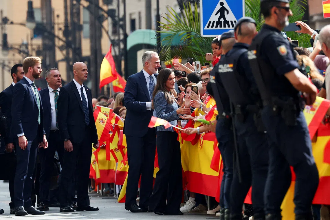Spain's King Felipe and Queen Letizia greet people as they arrive to visit the Ceuta town hall and seat of government, in Ceuta, Spain, October 13, 2026. REUTERS/Pedro Nunes