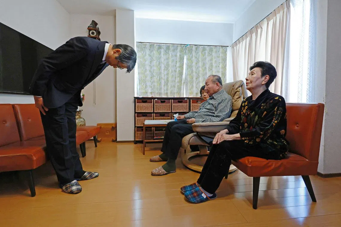 Regional chief prosecutor Hideo Yamada (left) apologises to Mr Iwao Hakamada (second from right) as his sister Hideko Hakamada (right) looks on.