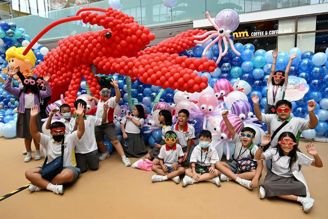 Beneficiaries from The Straits Times School Pocket Money Fund enjoying themselves at the Balloon Extravaganza at Marina Square on March 10, 2023.