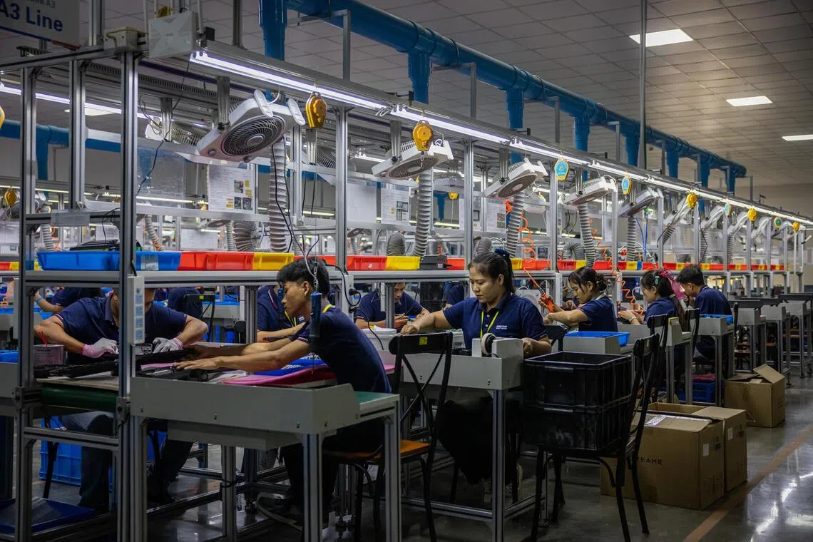Factory workers assemble lighting products at Ningbo Bright Electric in Rayong, Thailand, on July 20.