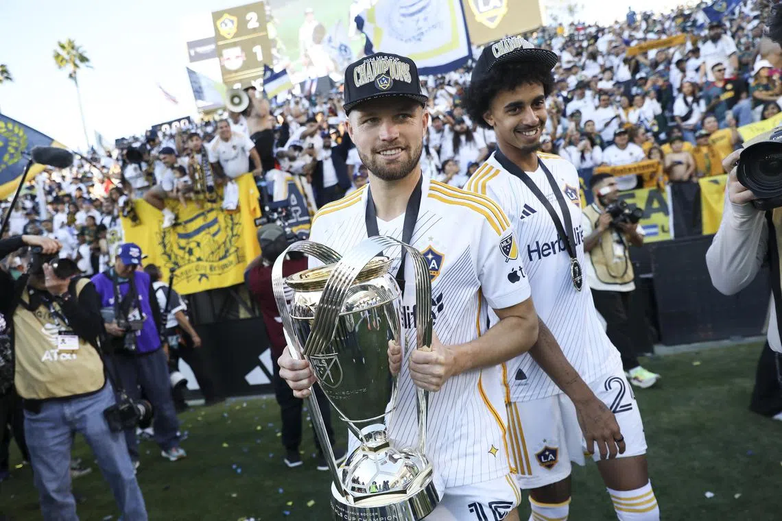 Los Angeles Galaxy defender Eriq Zavaleta holds the Philip F. Anschutz trophy after they won the Major League Soccer (MLS) Cup final against the New York Red Bulls.