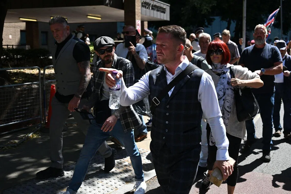 British far-right activist Tommy Robinson, whose real name is Stephen Yaxley-Lennon, reacts as he leaves Southwark Crown court on July 3, 2025, charged with "harassment" of two journalists. (Photo by JUSTIN TALLIS / AFP)