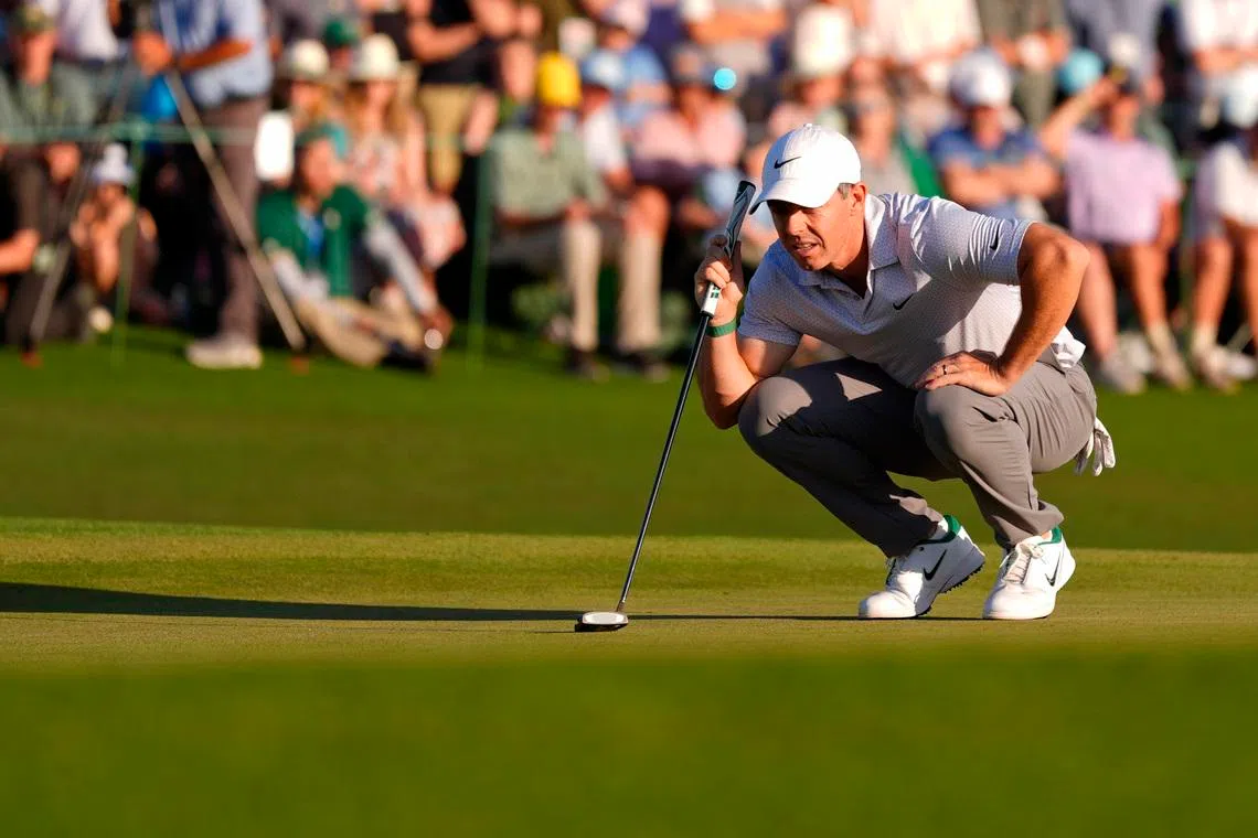 Rory McIlroy lines up a putt on the 18th green during the second round of the Masters Tournament at Augusta National Golf Club.