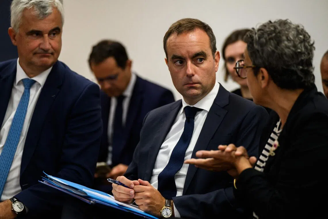 Newly appointed France’s Prime Minister Sebastien Lecornu (C) attending a meeting as he visits the departmental health centre in Macon, central eastern France, on Sept 13, 2025. 
