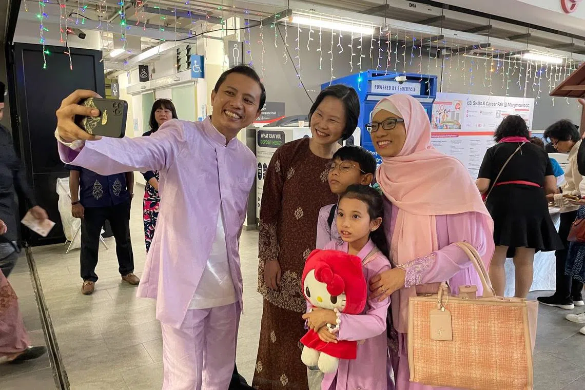 Minister of State for Manpower and Education Gan Siow Huang taking photos with residents at a Hari Raya celebration at Marymount CC on April 20.