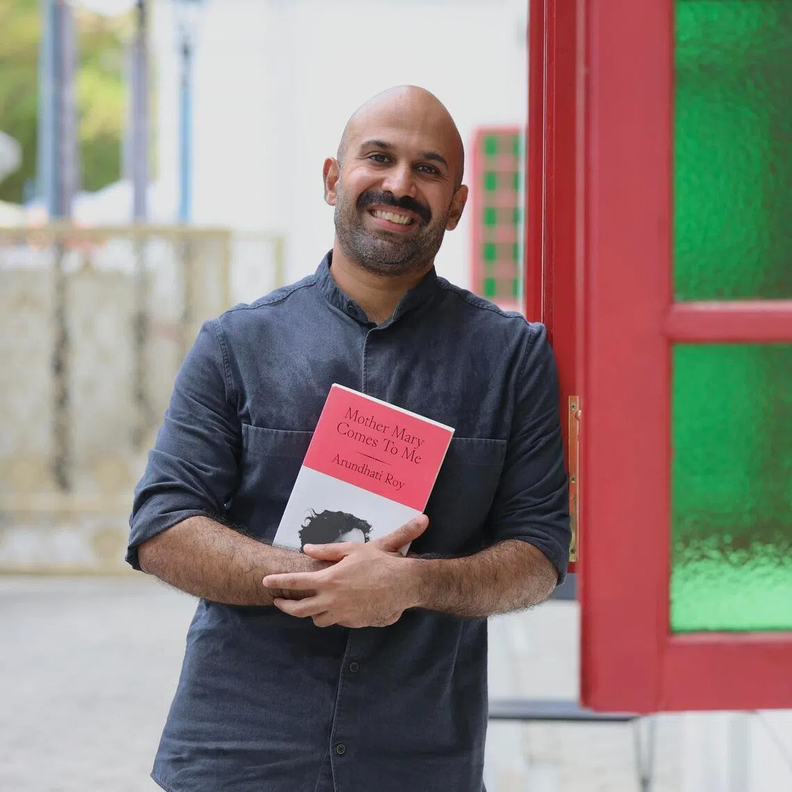 Shridar Mani, co-artistic director of The Opera People, likes to read on his commute. 
ST Photo: Hester Tan