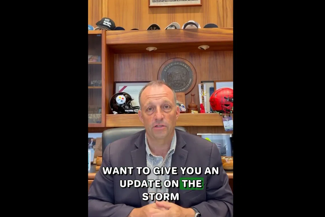 A man in an office speaking with text overlay about a storm update.