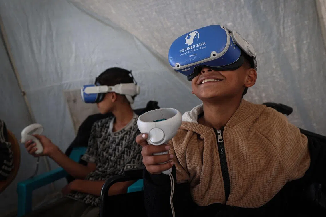 Inside a white tent pitched on a sandy patch of ground in Al-Zawayda, in central Gaza, excited chatter swelled as five boys roamed around a virtual world.