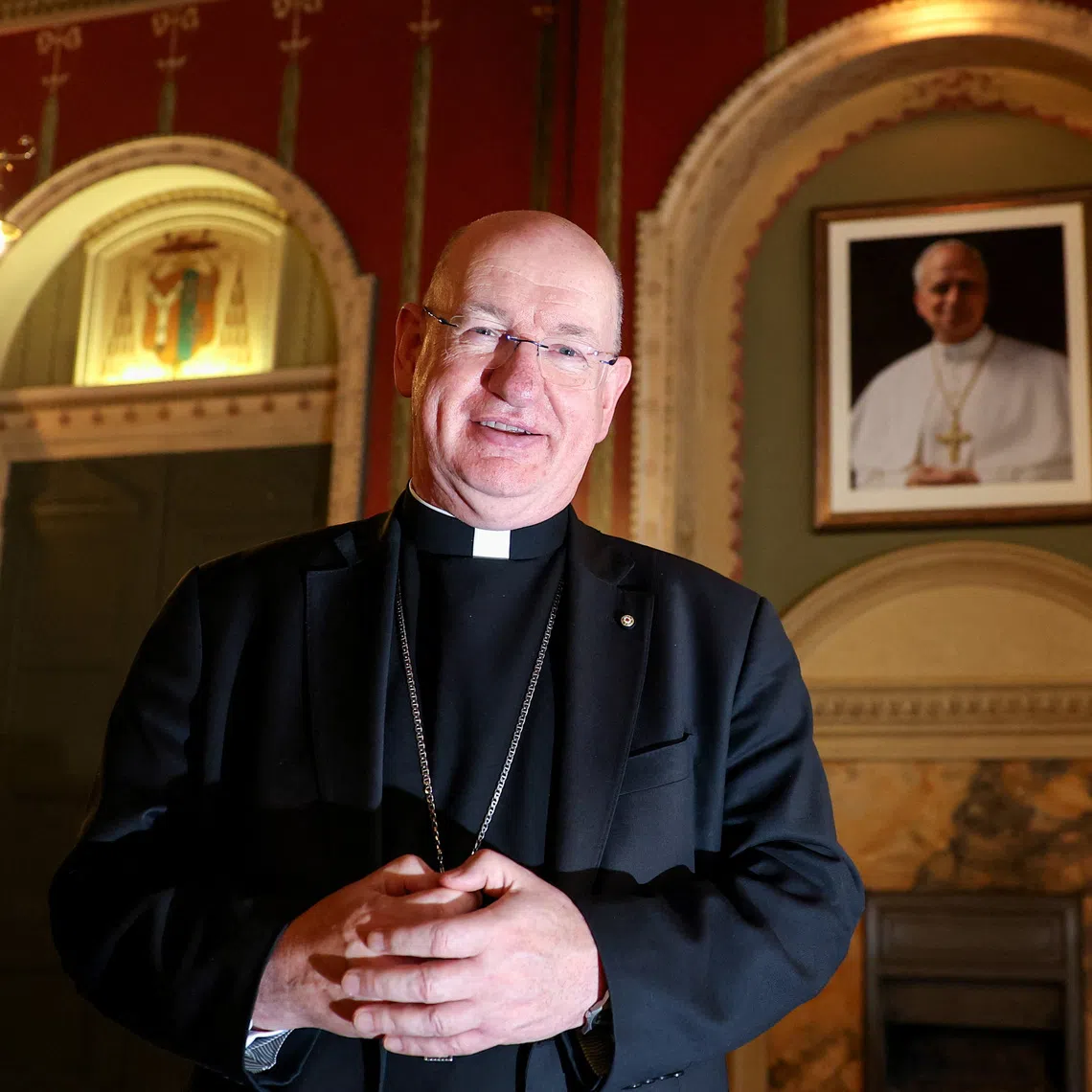 Richard Moth, newly appointed as Archbishop of Westminster, poses for a photograph in front of a portrait of Pope Leo XIV at the Archbishop's House, in London, Britain, December 19, 2025. REUTERS/Toby Melville