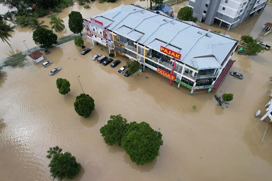 A view of shop-lots and vehicles submerged in flood waters in Shah Alam, Selangor state, Malaysia, December 19, 2021. Picture taken with a drone. REUTERS/Ebrahim Harris NO RESALES. NO ARCHIVES


