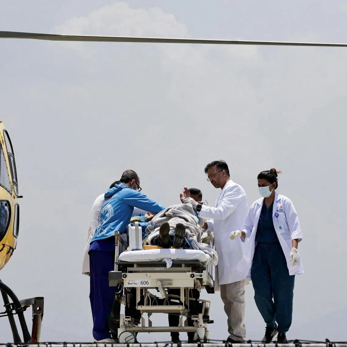 Paramedics work to transport Dawa Sherpa, who was missing for several days in the Everest region, from the helipad at HAMS Hospital in Kathmandu, Nepal, on June 4. 