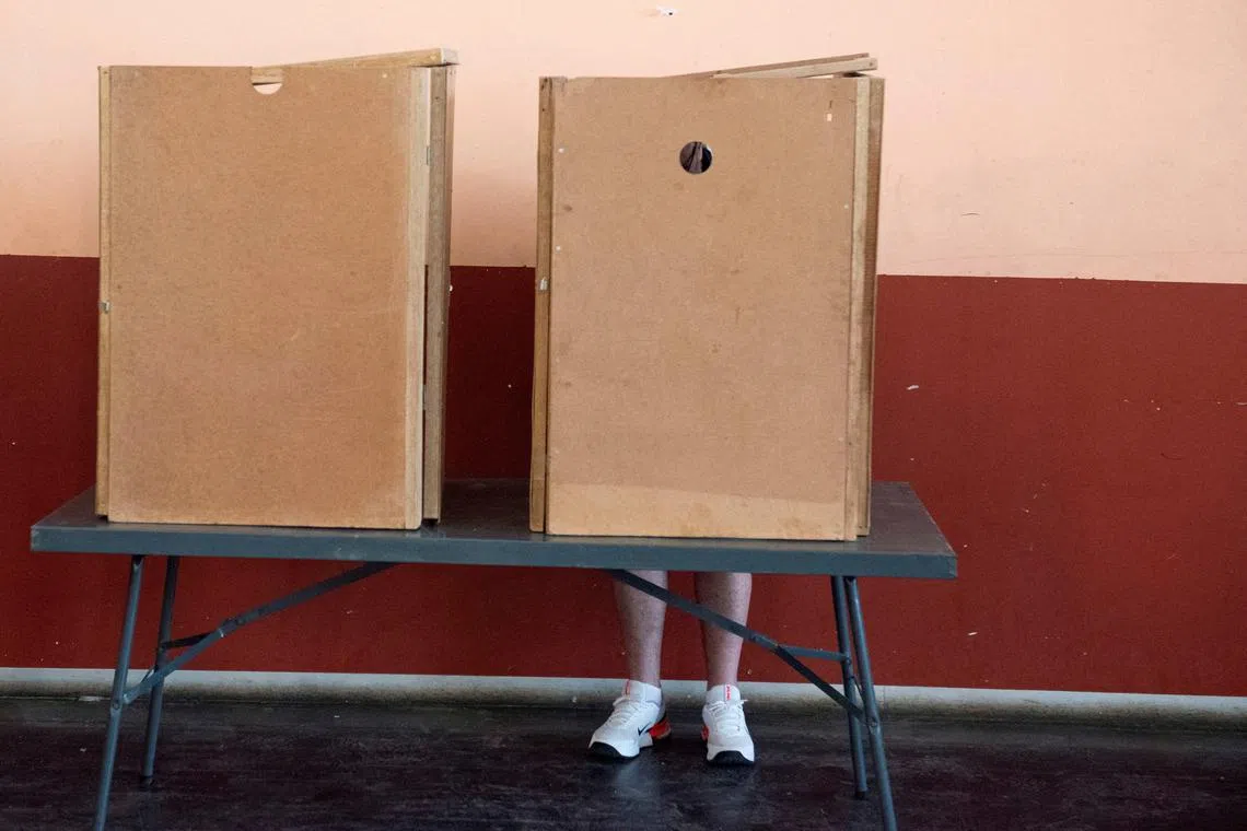 FILE PHOTO: A person votes in an extension of the presidential and national assembly elections after delays on the official election day earlier this week in Windhoek, Namibia, November 29, 2024. REUTERS/Noah Tjijenda/File Photo