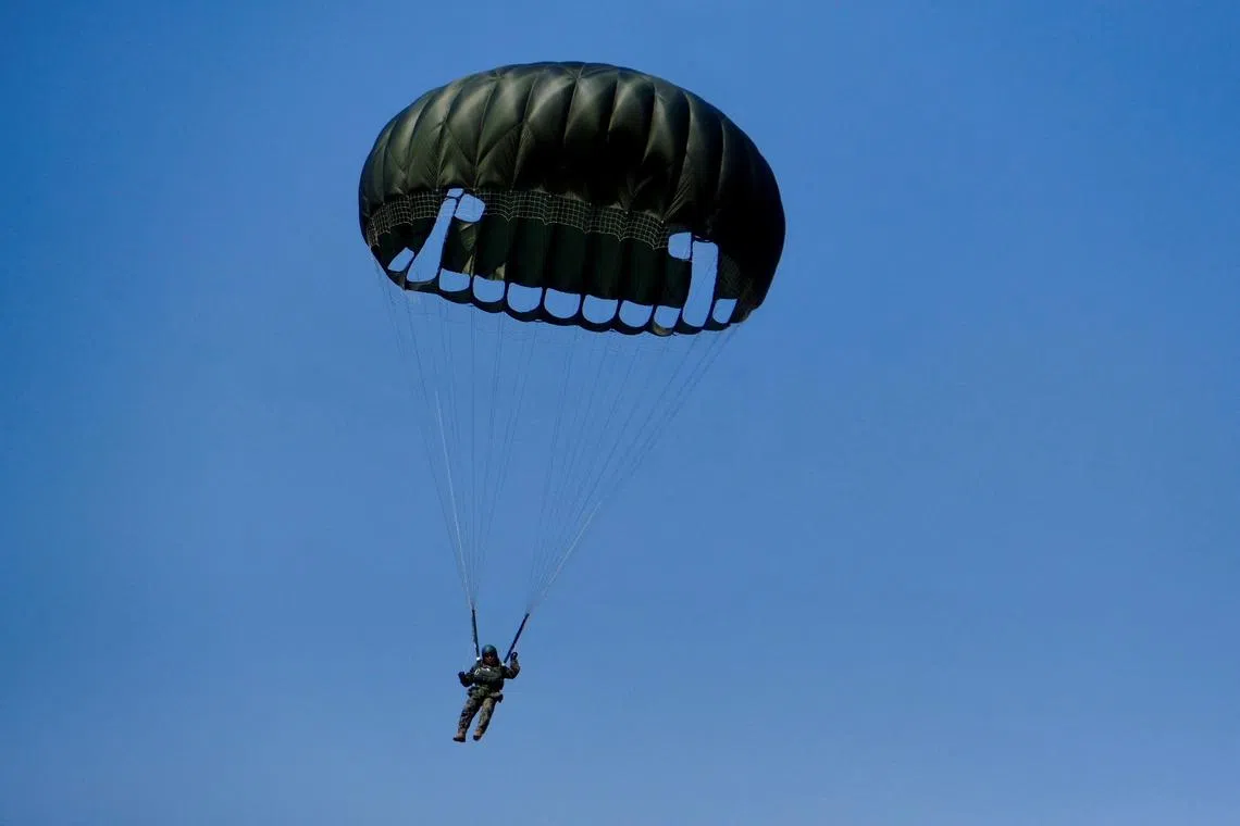 FILE PHOTO: A member of South Korea's Army Special Warfare Command parachutes from a MC-130 airplane during their military exercise with U.S. Special Operations Command which is a part of the annual Freedom Shield joint military training between South Korea and the United States in Gwangju, South Korea, March 14, 2024.   REUTERS/Josh Smith/File Photo