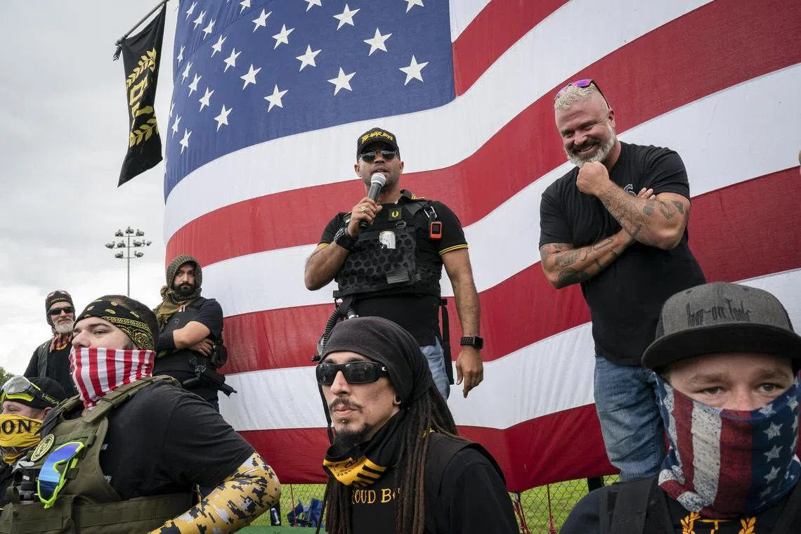A 2020 photo shows Joseph Biggs (right), then a lieutenant in the Proud Boys, with chairman Enrique Tarrio, during a rally in Portland, Oregon.