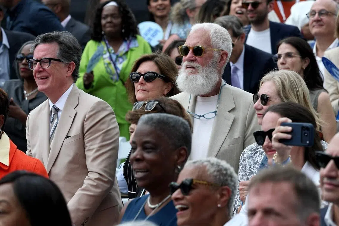Stephen Colbert (left) and David Letterman dressed in similar khaki suits at the dedication ceremony for the opening of the Barack Obama Presidential Center in Chicago, Illinois, on June 18.