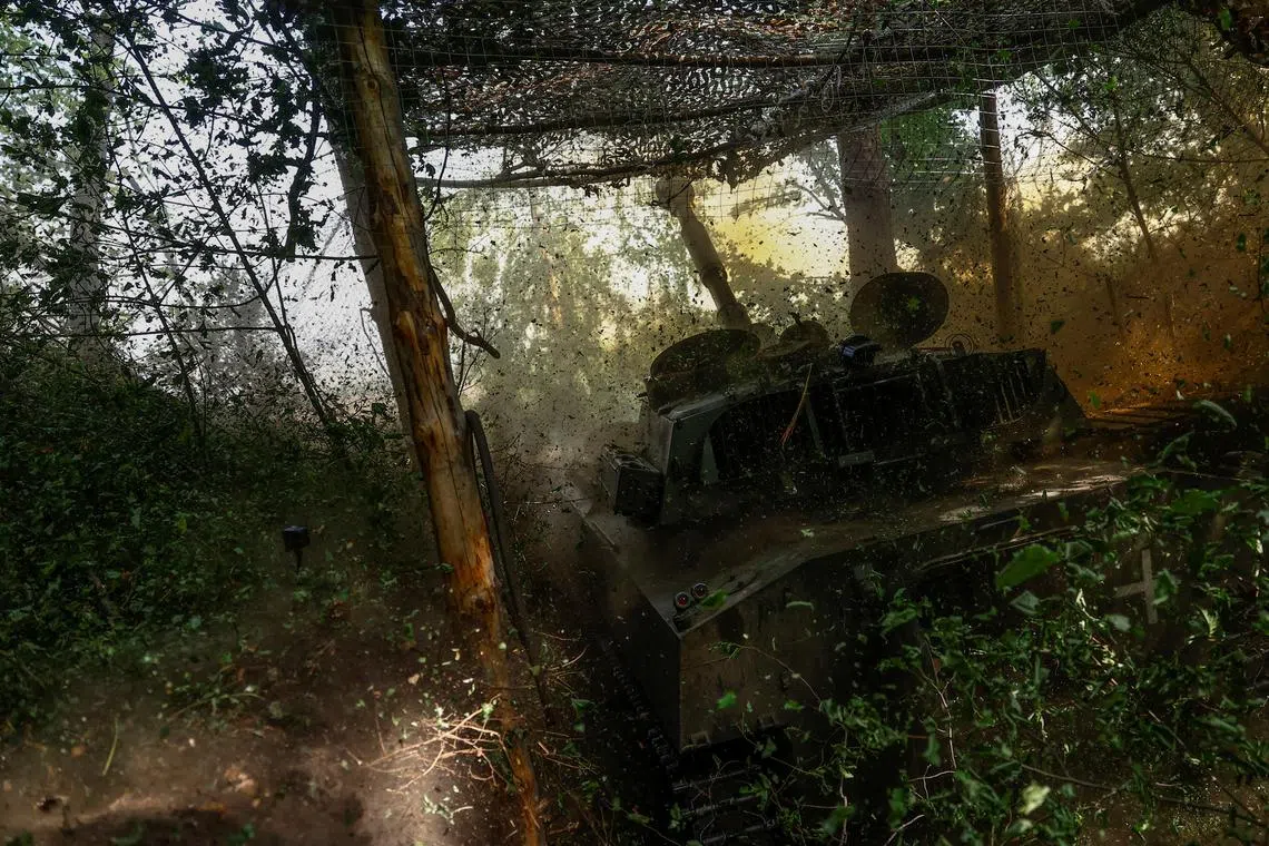 FILE PHOTO: Ukrainian servicemen of the 42nd Separate Mechanized Brigade fire a 2S1 Gvozdika self-propelled howitzer towards Russian troops in a front line, amid Russia's attack on Ukraine, in Kharkiv region, Ukraine May 16, 2024. REUTERS/Valentyn Ogirenko/File Photo