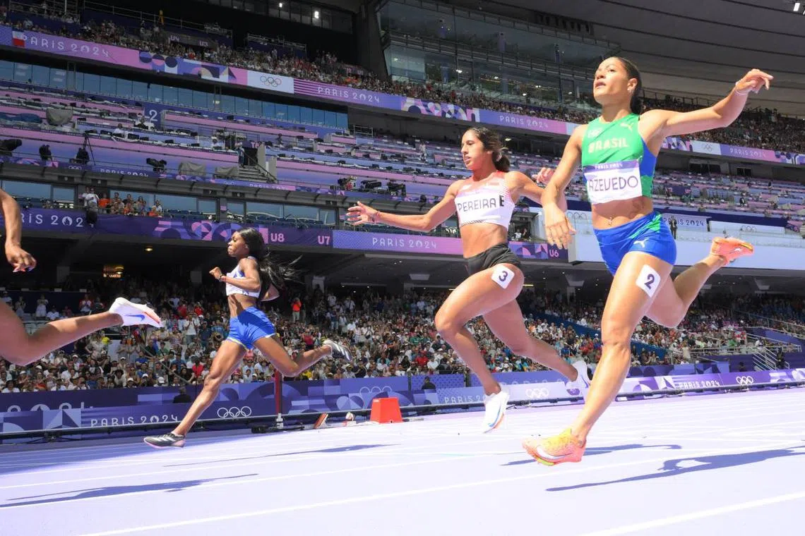 Shanti Pereira (second from right) finishes last in the repechage round of the women's 200m and fails to qualify.