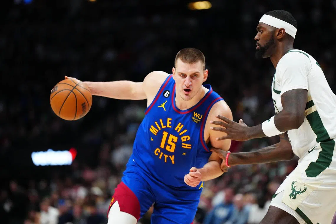Denver Nuggets centre Nikola Jokic (No. 15) driving at Milwaukee Bucks forward Bobby Portis (No. 9) during the second half of their NBA clash on Saturday.  