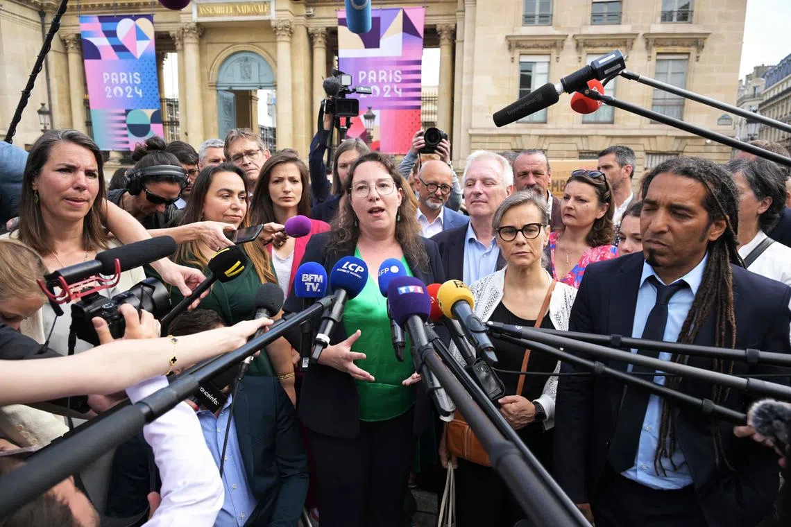 French newly-elected Member of Parliament (MP) for The Ecologistes green party (EELV) of the leftist coalition "Nouveau Front Populaire" (New Popular Front - NFP) Cyrielle Chatelain (C) speaks to journalists as she arrives to the National Assembly in Paris, on July 9.