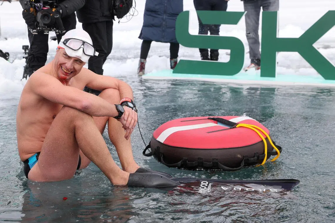 Free-diver plunges to record depth beneath frozen Swiss lake without ...