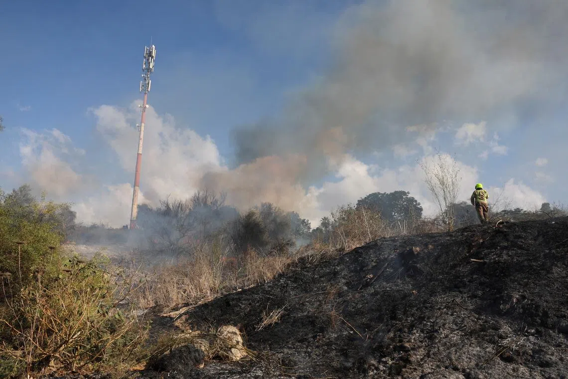 Smoke billows after a missile attack from Yemen in central Israel, September 15, 2024. REUTERS/Ronen Zvulun/File Photo