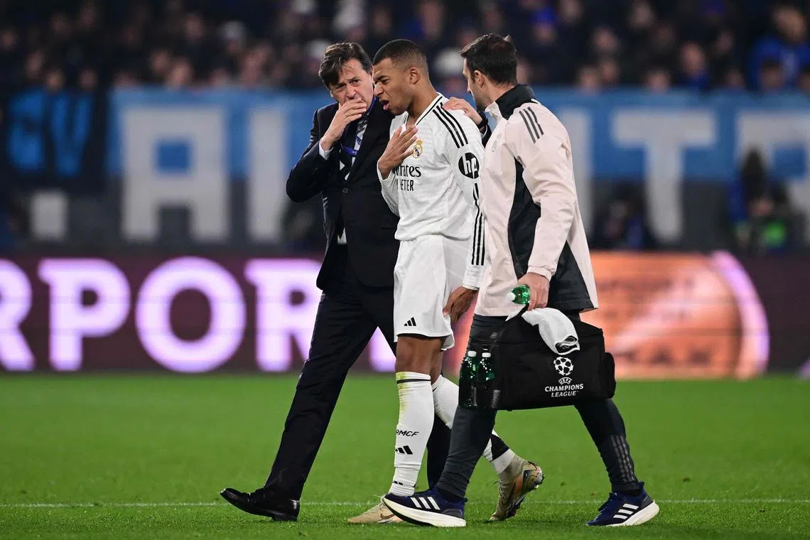 Real Madrid's injured striker Kylian Mbappe leaving the pitch during their Champions League match against Atalanta, on Dec 10.