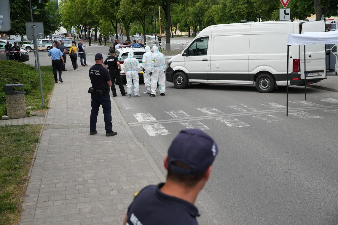 Scientific police investigators work near the cordoned-off crime scene where Slovak Prime Minister Robert Fico was shot earlier in the day.
