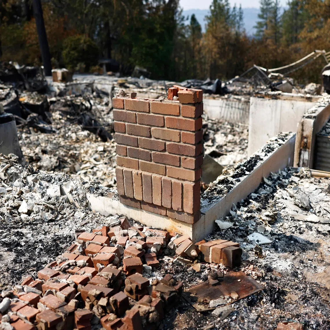 SPOKANE, WASHINGTON - AUGUST 06: Jim Zimmer searches through the remains of his home which was destroyed in the Old Trails Fire on August 6, 2026 in Spokane, Washington. Fueled by strong winds amid drought, fast-moving wildfires burned over 10,000 acres combined in the Spokane area over the weekend, destroying more than 700 structures, including many homes. 65,000 people were forced to evacuate, and one man was arrested on suspicion of first-degree arson in the Old Trails Fire.   Mario Tama/Getty Images/AFP (Photo by MARIO TAMA / GETTY IMAGES NORTH AMERICA / Getty Images via AFP)