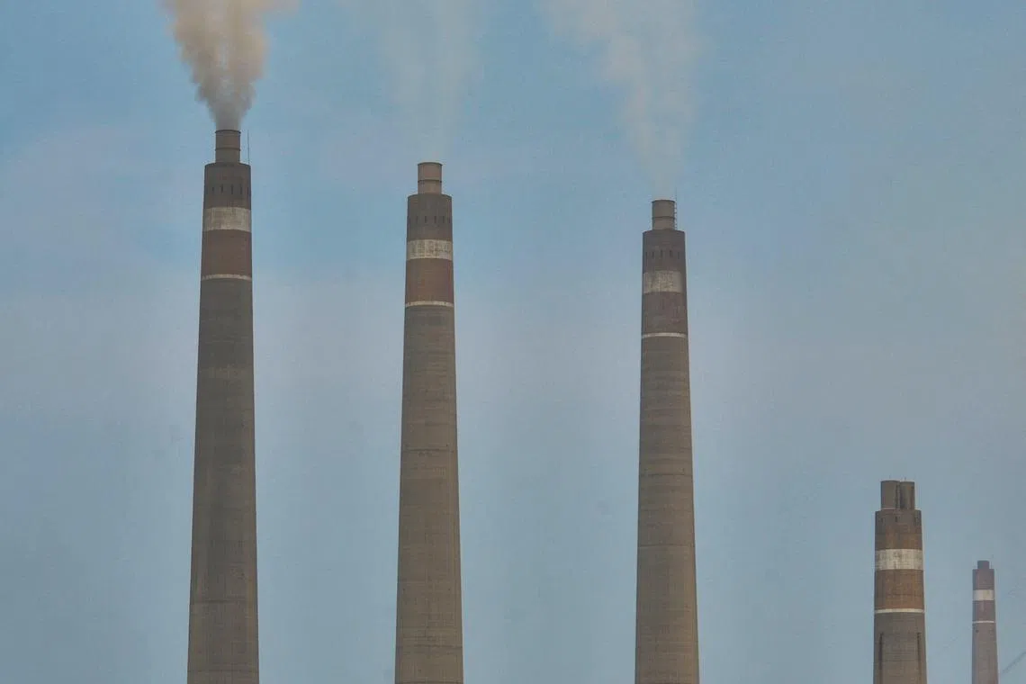 This picture taken on October 31, 2023 shows the Suralaya coal-fired power plant in Cilegon, Indonesia's Banten province. As countries gather in Dubai for crunch climate talks, the future of polluting fossil fuel coal will be high on the agenda. For some, the age of coal is now clearly over, and Indonesia has committed to moving away from the fuel despite being the world's top exporter. (Photo by Ronald SIAGIAN / AFP) / To go with AFP story Climate-UN-COP28-UAE-Indonesia-coal,FOCUS by Dessy SAGITA and Marchio GORBIANO